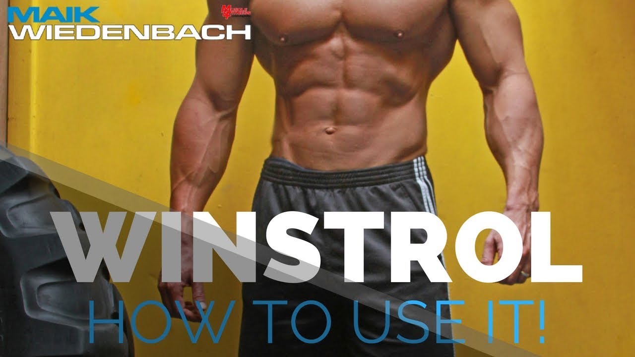 Muscular man in shorts standing next to a large tire, promoting Winstrol usage for performance enhancement.
