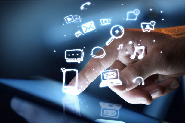 A hand touching a tablet screen with floating digital icons representing communication and social media.